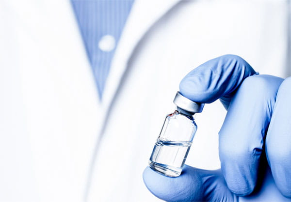 Scientist holding a glass vial