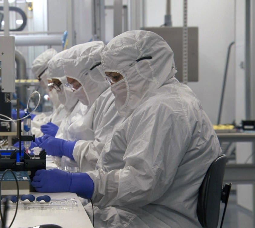 Personnel in a cleanroom conducting sterile manufacturing under EU GMP compliance standards