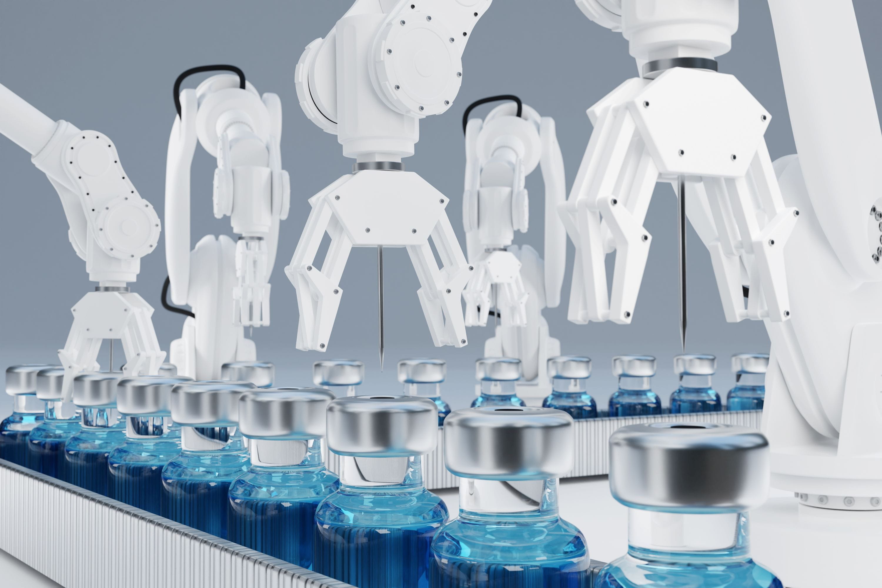 Robotic arms handling vials on a pharmaceutical production line