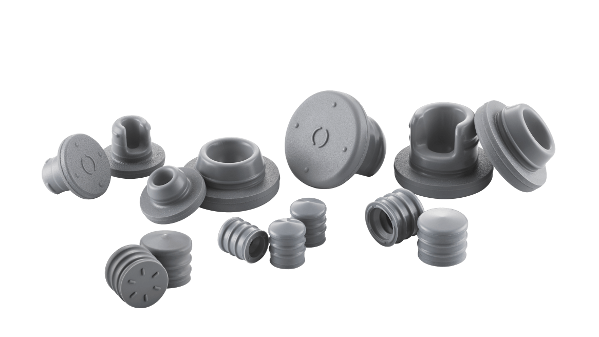 Assorted gray NovaPure elastomer components, including stoppers and plungers, arranged on a dark background.